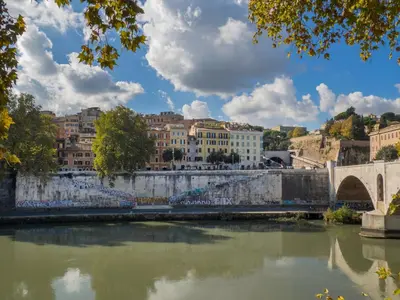 a bridge over a river with buildings in the background at River View Apartment in Rome