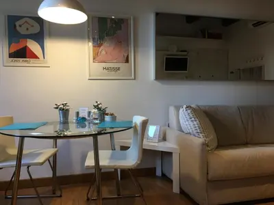 a living room with a table and a couch at River View Apartment in Rome