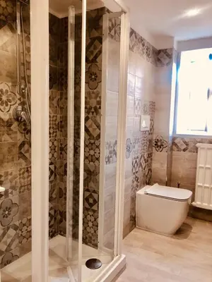 a bathroom with a toilet and a glass shower at Heart of Rome Vatican Deluxe New Apartment 1GB WiFi in Rome