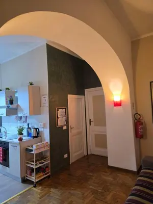 a kitchen with a table and chairs in a room at Casa Tua a Porta Maggiore in Rome