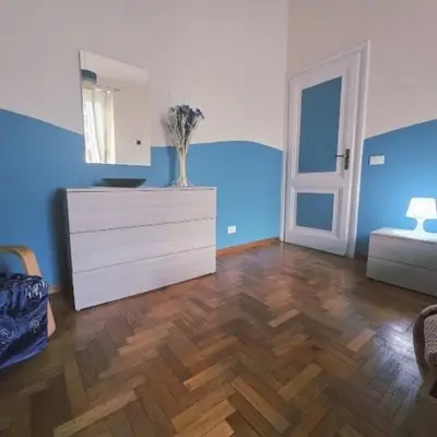 a living room with a chair and a television at Casa Tua a Porta Maggiore in Rome