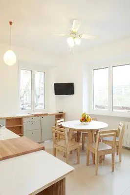a dining room with a table and chairs and windows at Testaccio Old Rome Apartment in Rome