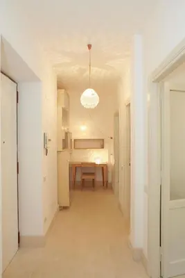 a hallway with a table and a dining room at Testaccio Old Rome Apartment in Rome