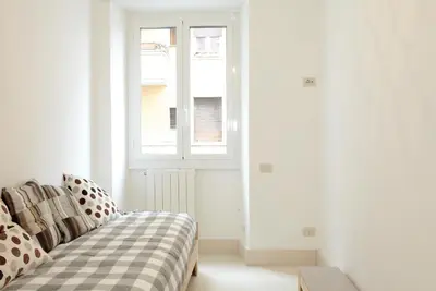 a living room with a couch and a window at Testaccio Old Rome Apartment in Rome