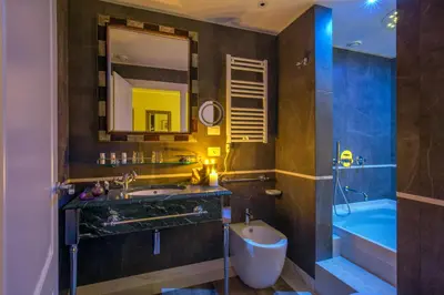 a bathroom with a sink and a tub and a mirror at Hotel Monte Cenci in Rome