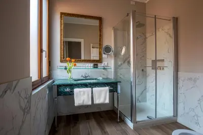a bathroom with a shower and a sink and a mirror at Hotel Monte Cenci in Rome