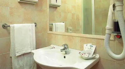a bathroom with a sink and a mirror at Hotel Stromboli in Rome