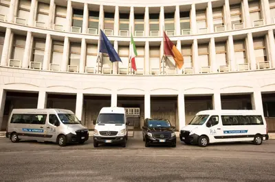 a group of vehicles parked in front of a building at B&B Fantasie Romane in Rome