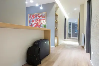 a hallway with a bag of luggage next to a wall at B&B Fantasie Romane in Rome