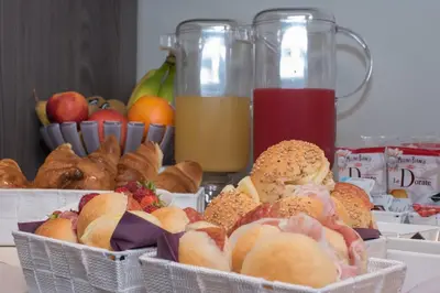 two baskets filled with different types of bread and fruit at B&B Fantasie Romane in Rome