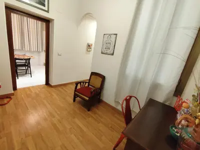a living room with a table and a chair at Milazzo23 Guesthouse in Rome