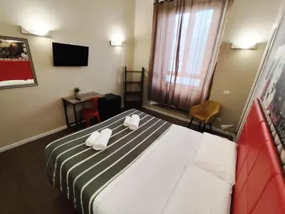 a bedroom with a bed with two white towels on it at Milazzo23 Guesthouse in Rome