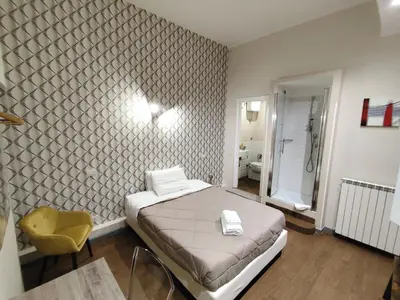 a bedroom with a bed and a bathroom at Milazzo23 Guesthouse in Rome