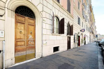 a building with a large wooden door on a street at Colosseum Suite in Rome