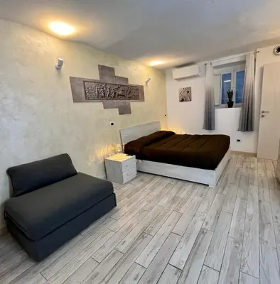 a bedroom with a bed and a couch in it at Colosseum Suite in Rome