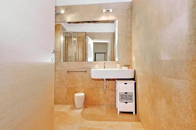 a bathroom with a sink and a mirror at Colosseum Suite in Rome