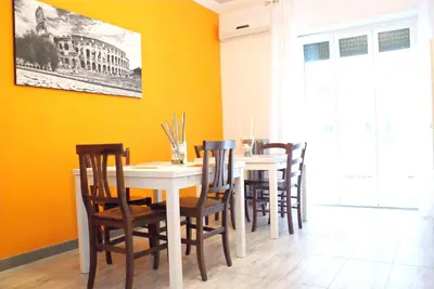a dining room with a white table and chairs at Like Family House in Rome