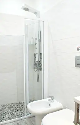 a bathroom with a shower and a toilet and a sink at Like Family House in Rome