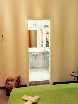 a bedroom with a bed with a wooden cross on it at Like Family House in Rome
