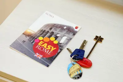 a book with a photo and a pair of scissors at Holiday rental San Lorenzo district in Rome