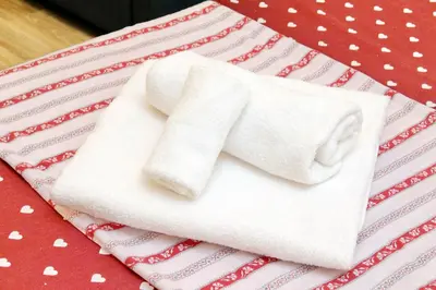 a pile of towels sitting on top of a table at Holiday rental San Lorenzo district in Rome