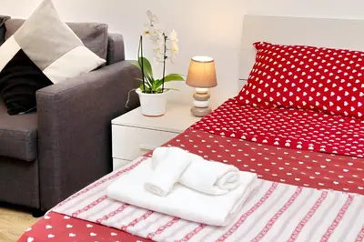 a bedroom with a red bed with polka dots at Holiday rental San Lorenzo district in Rome