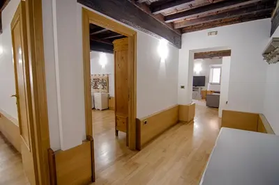 an open room with a wooden door and a hallway at Rinidia - Roma Centro in Rome