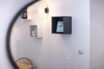 a room with a wall with pictures and a mirror at Interno 6 San Pietro in Rome