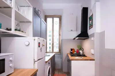 a kitchen with a white refrigerator and a sink at Interno 6 San Pietro in Rome