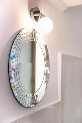 a bathroom mirror with a glass mosaic tile on a wall at Interno 6 San Pietro in Rome
