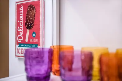 a group of colorful glasses sitting on a shelf at Interno 6 San Pietro in Rome