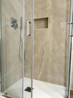 a shower with a glass door in a bathroom at Casa Blaserna nel Cuore dello Shopping a Marconi e Trastevere in Rome