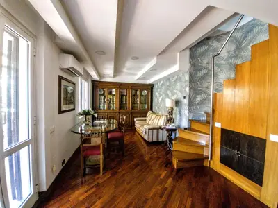 a living room with a couch and a table at Frattina Family Romantic Superior Suite in Rome