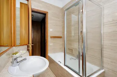 a bathroom with a sink and a shower at Frattina Family Romantic Superior Suite in Rome
