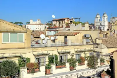 a group of buildings with potted plants on the balconies at Frattina Family Romantic Superior Suite in Rome