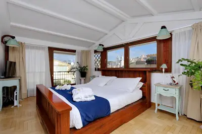 a bedroom with a large bed with towels on it at Frattina Family Romantic Superior Suite in Rome