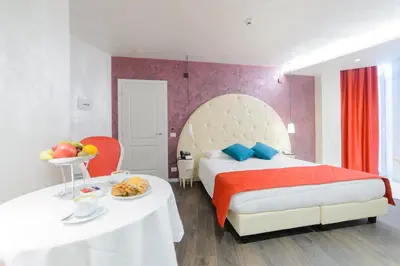 a bedroom with a bed and a table with food on it at Hotel Vespasiano in Rome