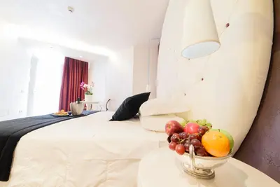 a bedroom with a bed with a bowl of fruit on a table at Hotel Vespasiano in Rome