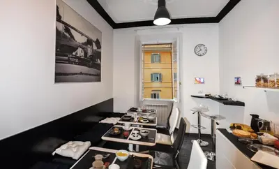 a dining room with tables and chairs and a clock at Good Life Via Veneto in Rome