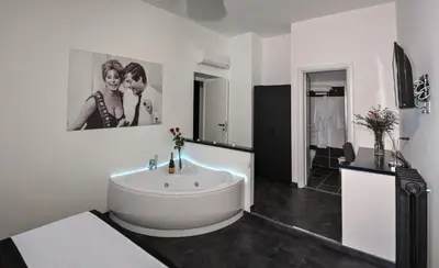 a bathroom with a large white tub and a sink at Good Life Via Veneto in Rome
