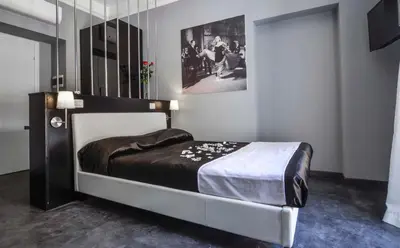 a bedroom with a large bed in a room at Good Life Via Veneto in Rome