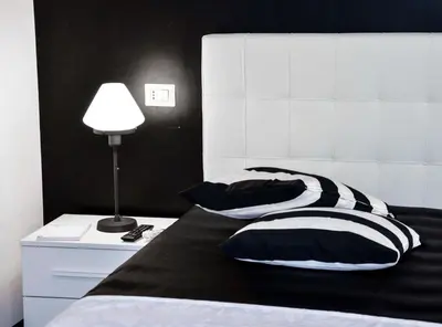 a bedroom with two pillows on a bed with a lamp at Good Life Via Veneto in Rome