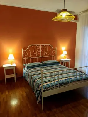 a bedroom with a bed and two tables with lamps at RoRo Roma in Rome