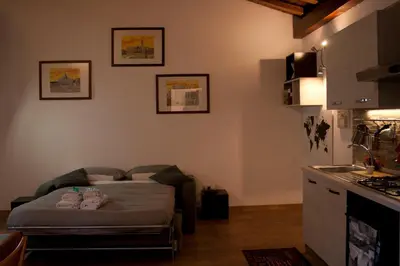 a living room with a bed and a kitchen at Le Scalette in Rome