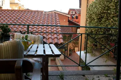 a balcony with a wooden table and chairs on a balcony at Le Scalette in Rome