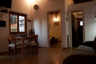 a living room with a dining room table and chairs at Le Scalette in Rome