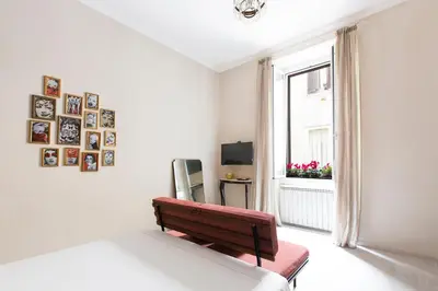 a white room with a bench and a window at Dandy Suite in Rome