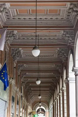 a row of lights hanging from the ceiling of a building at Dandy Suite in Rome