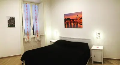 a bedroom with a bed and a painting on the wall at Sweet Roman Dream in Rome