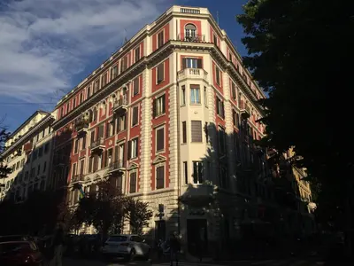 a large red and white building on a street at Sweet Roman Dream in Rome